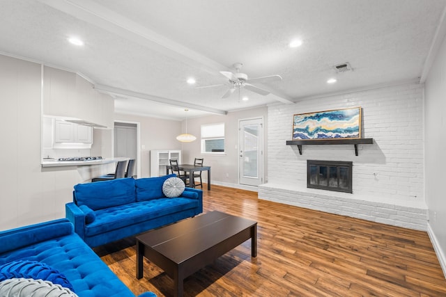 1432 Foothill Dr, Hurst, TX 76053 - living area with wood finished floors, recessed lighting, a fireplace, a ceiling fan, and a textured ceiling