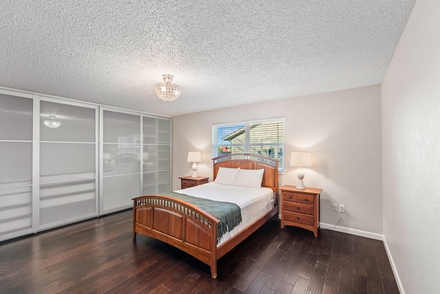 1432 Foothill Dr, Hurst, TX 76053 - bedroom featuring a chandelier, wood-type flooring, and a textured ceiling