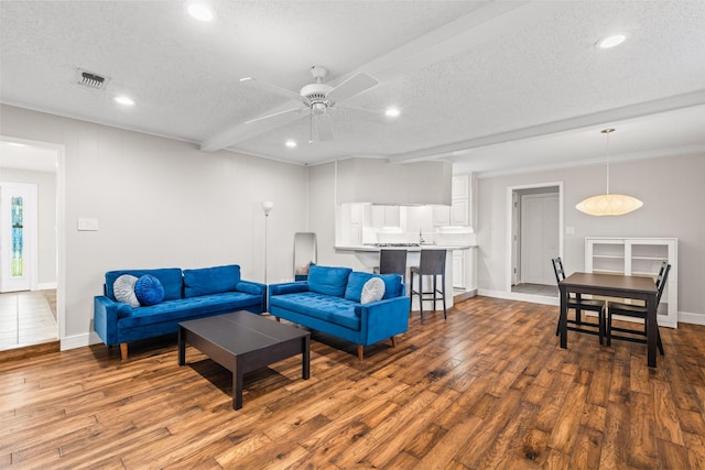 1432 Foothill Dr, Hurst, TX 76053 - living area featuring a textured ceiling, wood finished floors, recessed lighting, ceiling fan, and ornamental molding