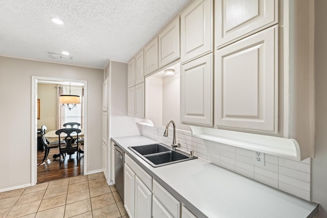 1432 Foothill Dr, Hurst, TX 76053 - kitchen with a textured ceiling, light countertops, decorative backsplash, dishwasher, and light tile patterned flooring