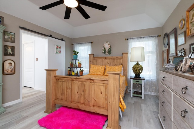 874 Havenbrook Dr, Arlington, TX 76001 - bedroom with multiple windows, lofted ceiling, light wood-style floors, a barn door, and ceiling fan