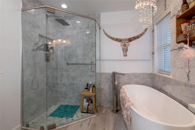 874 Havenbrook Dr, Arlington, TX 76001 - full bathroom with a freestanding tub, a stall shower, wood finished floors, and tile walls