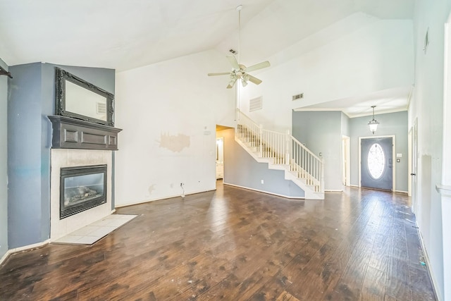 17 Zachary Ct, Mansfield, TX 76063 - unfurnished living room with wood-type flooring, stairs, a tile fireplace, a ceiling fan, and high vaulted ceiling