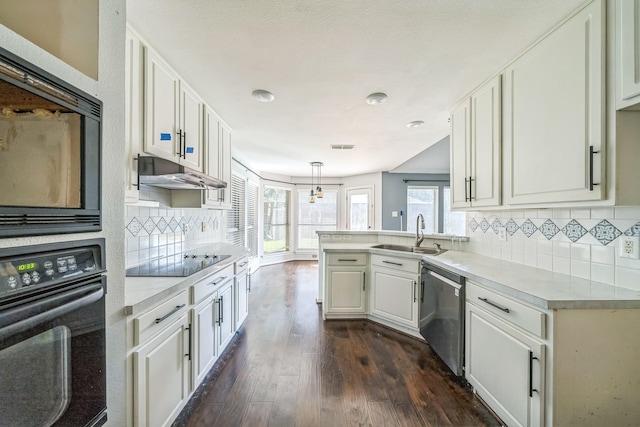 17 Zachary Ct, Mansfield, TX 76063 - kitchen with black appliances, under cabinet range hood, light countertops, white cabinetry, and dark wood-style floors