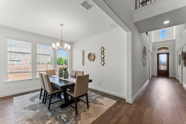 8133 Blumelia Dr, Dallas, TX 75252 - dining area featuring a chandelier, dark wood-style floors, and a high ceiling