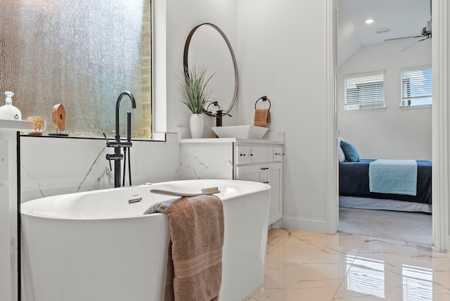 8133 Blumelia Dr, Dallas, TX 75252 - bathroom with a soaking tub, marble finish flooring, ensuite bathroom, vanity, and a ceiling fan