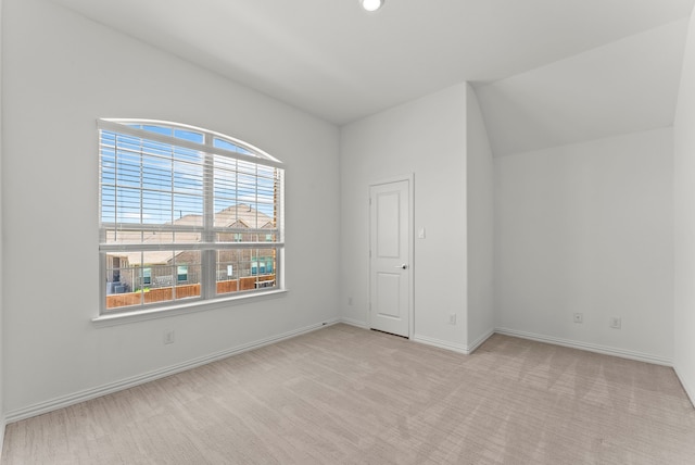 8133 Blumelia Dr, Dallas, TX 75252 - unfurnished bedroom featuring light carpet and vaulted ceiling