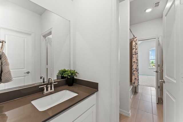 8133 Blumelia Dr, Dallas, TX 75252 - bathroom featuring vanity, tile patterned flooring, and shower / bathtub combination with curtain