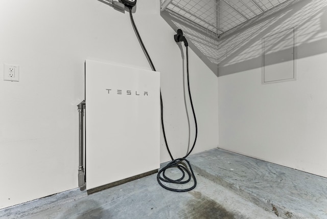 8133 Blumelia Dr, Dallas, TX 75252 - garage view of a power storage unit and concrete floors