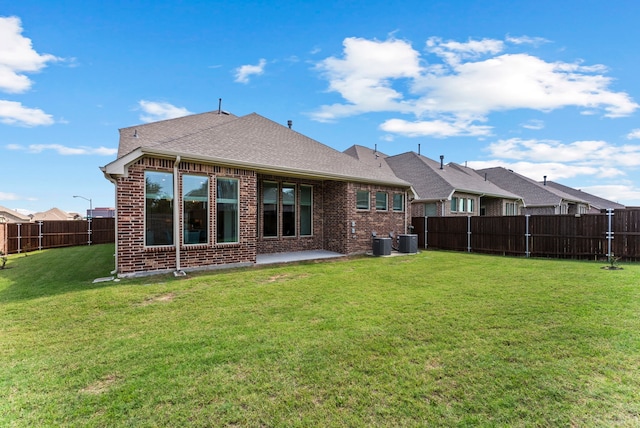8133 Blumelia Dr, Dallas, TX 75252 - rear view of property featuring brick siding, a fenced backyard, a patio area, and roof with shingles