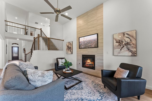 8133 Blumelia Dr, Dallas, TX 75252 - living room featuring a high ceiling, stairway, a fireplace, a ceiling fan, and recessed lighting