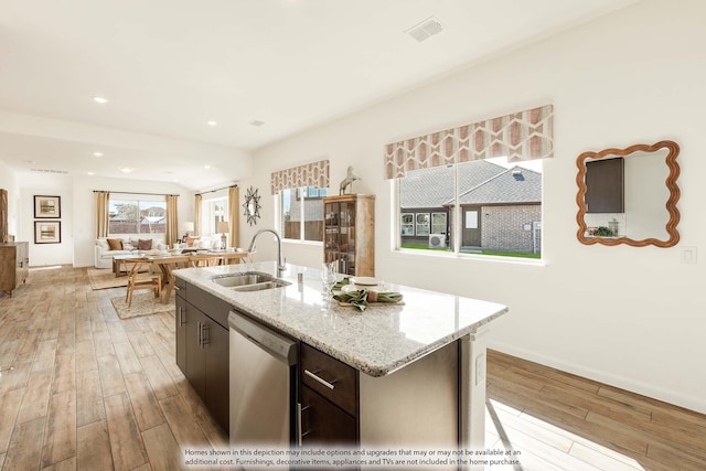 111 Cedar Grove Ct, Lavon, TX 75166 - kitchen with dishwasher, light wood-type flooring, an island with sink, light stone counters, and recessed lighting