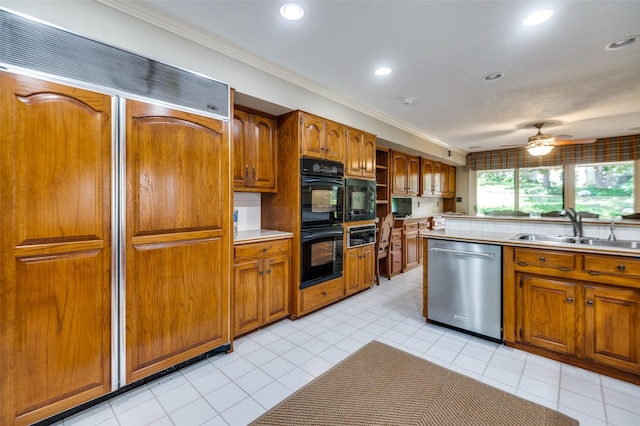 100 La Paz Ct, Irving, TX 75062 - kitchen with black appliances, brown cabinets, ornamental molding, light countertops, and ceiling fan