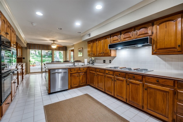 100 La Paz Ct, Irving, TX 75062 - kitchen with dishwasher, cooktop, under cabinet range hood, brown cabinets, and crown molding