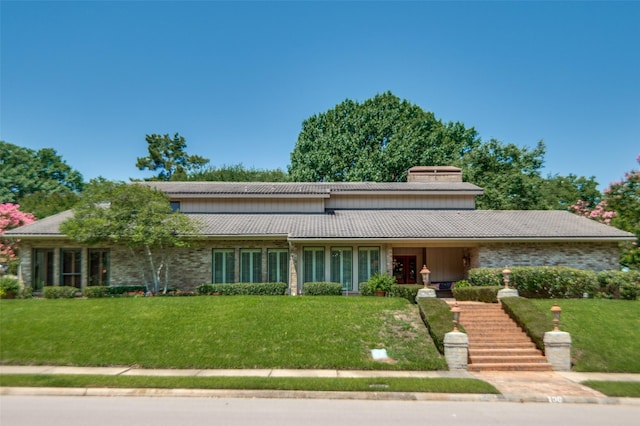 100 La Paz Ct, Irving, TX 75062 - view of front of property featuring a front lawn, a tiled roof, and a chimney