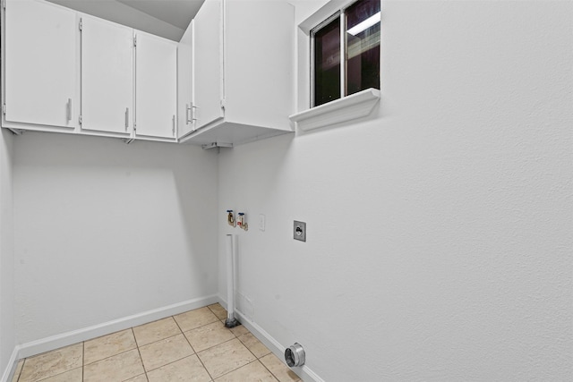 7005 Culver Ave, Fort Worth, TX 76116 - washroom featuring cabinet space, electric dryer hookup, light tile patterned flooring, and washer hookup
