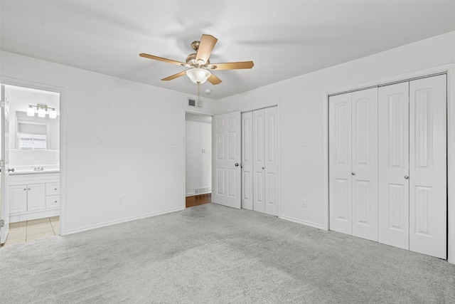 7005 Culver Ave, Fort Worth, TX 76116 - unfurnished bedroom with two closets, carpet flooring, ensuite bath, and a ceiling fan