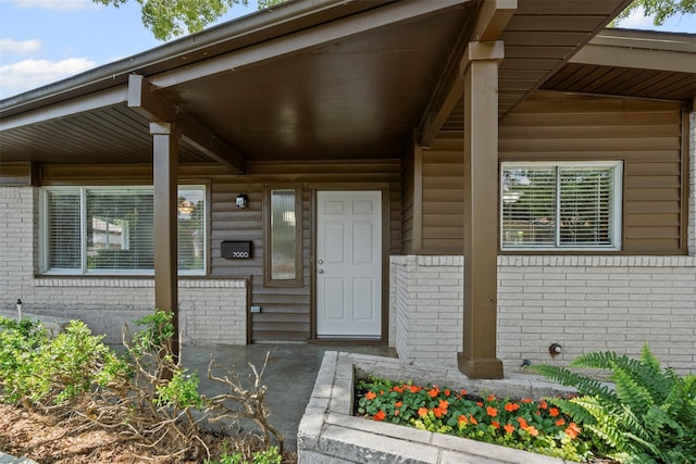 7005 Culver Ave, Fort Worth, TX 76116 - doorway to property featuring brick siding and a porch