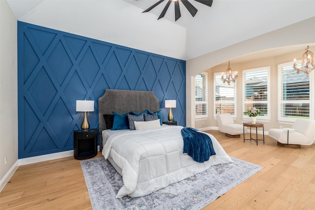 3208 Twin Eagles Dr, Celina, TX 75009 - bedroom featuring a chandelier, light wood-type flooring, arched walkways, and a decorative wall
