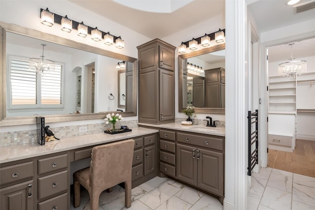 3208 Twin Eagles Dr, Celina, TX 75009 - full bathroom with a chandelier, marble look tile flooring, vanity, and a closet