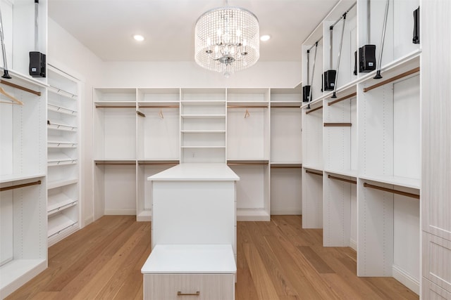 3208 Twin Eagles Dr, Celina, TX 75009 - walk in closet with light wood-style flooring and a chandelier