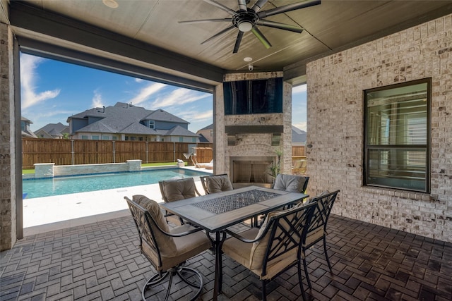 3208 Twin Eagles Dr, Celina, TX 75009 - fenced backyard featuring a ceiling fan, a fireplace, a patio area, and outdoor dining space