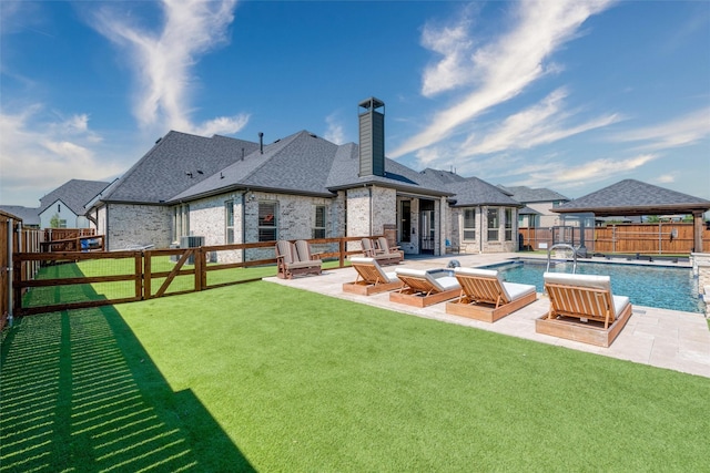 3208 Twin Eagles Dr, Celina, TX 75009 - back of house featuring a fenced backyard, a chimney, a gazebo, and a patio area