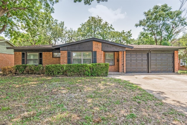 2406 Globe Ave, Dallas, TX 75228 - ranch-style home featuring an attached garage, brick siding, and concrete driveway
