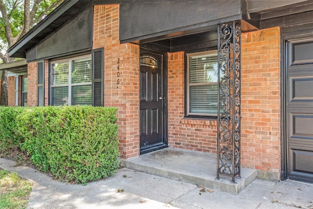 2406 Globe Ave, Dallas, TX 75228 - doorway to property featuring brick siding and a porch