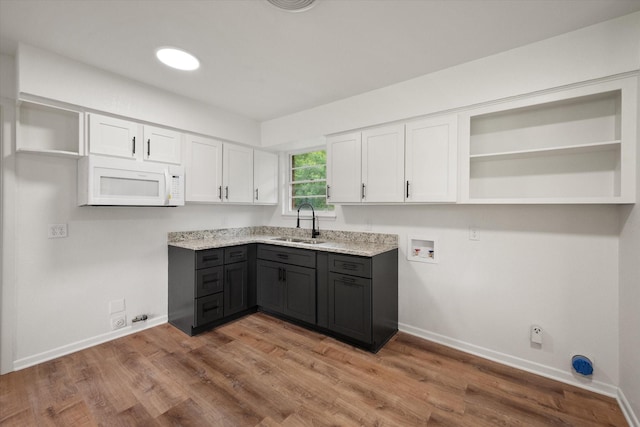 2040 Bowie Dr, Corsicana, TX 75110 - laundry room with gas dryer hookup, hookup for a washing machine, and wood finished floors