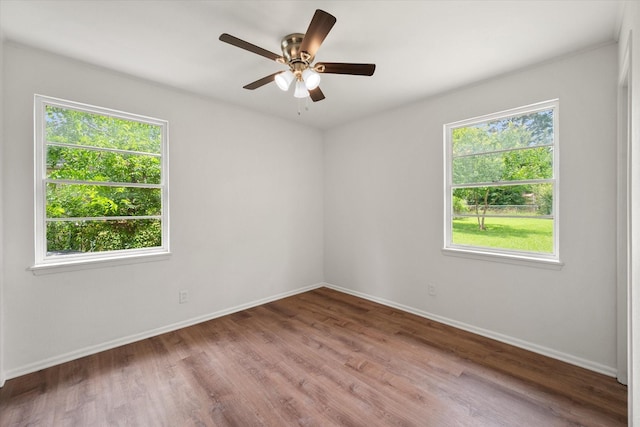 2040 Bowie Dr, Corsicana, TX 75110 - empty room with plenty of natural light, wood finished floors, and ceiling fan