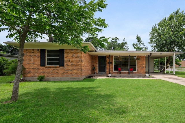 2040 Bowie Dr, Corsicana, TX 75110 - view of front of home with concrete driveway, a front lawn, brick siding, an attached carport, and covered porch