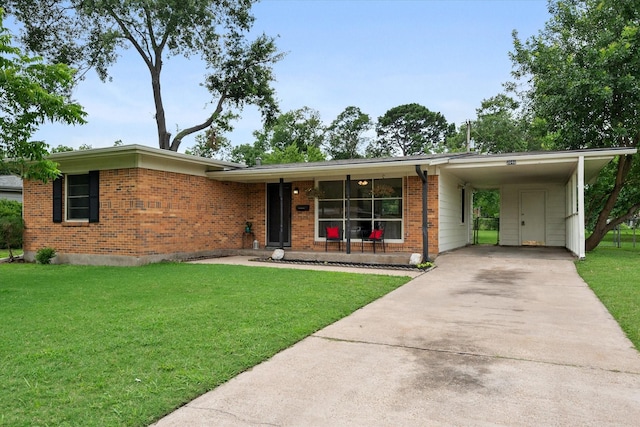 2040 Bowie Dr, Corsicana, TX 75110 - view of front facade featuring driveway, brick siding, a front lawn, and a carport