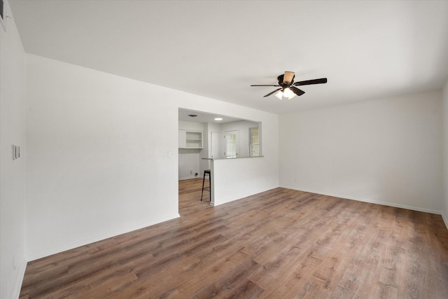 2040 Bowie Dr, Corsicana, TX 75110 - unfurnished living room featuring a ceiling fan and wood finished floors