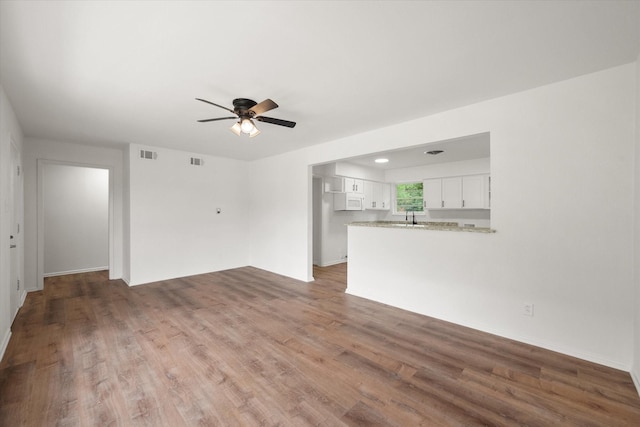 2040 Bowie Dr, Corsicana, TX 75110 - unfurnished living room featuring ceiling fan and wood finished floors