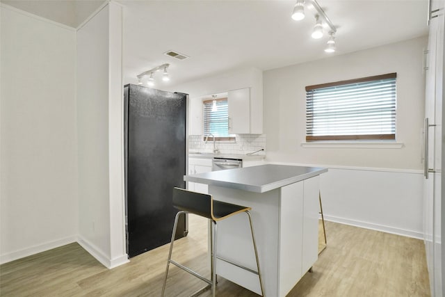 108 Sunnyvale Ter, Hurst, TX 76053 - kitchen featuring freestanding refrigerator, track lighting, and light wood-type flooring