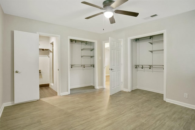 108 Sunnyvale Ter, Hurst, TX 76053 - unfurnished bedroom featuring wood finished floors, two closets, ensuite bath, and ceiling fan