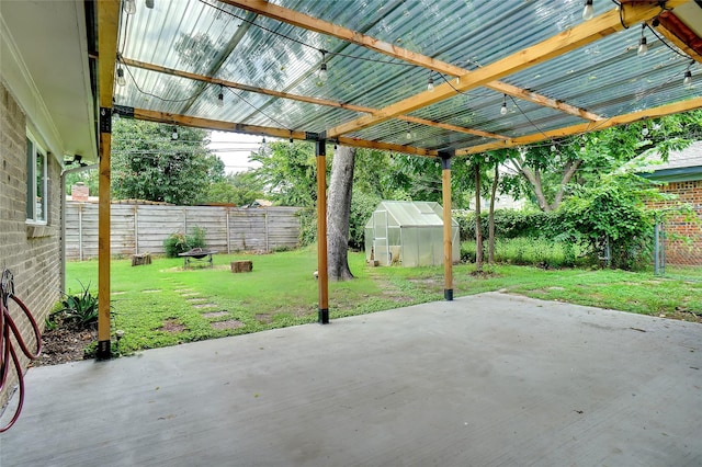 108 Sunnyvale Ter, Hurst, TX 76053 - fenced backyard featuring a greenhouse, a patio area, and an outbuilding