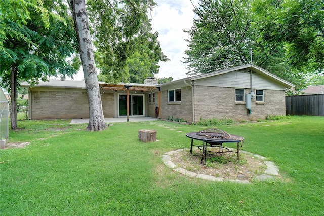 108 Sunnyvale Ter, Hurst, TX 76053 - back of property featuring a fire pit, a patio, a chimney, and brick siding