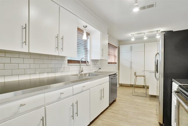 108 Sunnyvale Ter, Hurst, TX 76053 - kitchen with stainless steel appliances, decorative backsplash, and white cabinetry