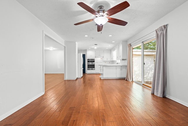 2333 Hermanson Dr, Waco, TX 76710 - unfurnished living room featuring ceiling fan, hardwood / wood-style floors, and recessed lighting