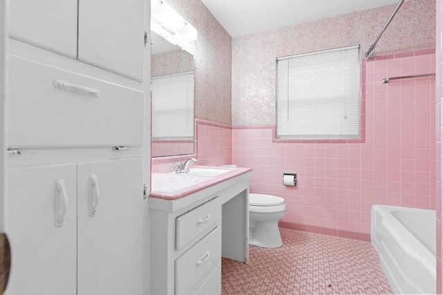2333 Hermanson Dr, Waco, TX 76710 - bathroom with vanity, tile walls, wainscoting, bathing tub / shower combination, and tile patterned floors