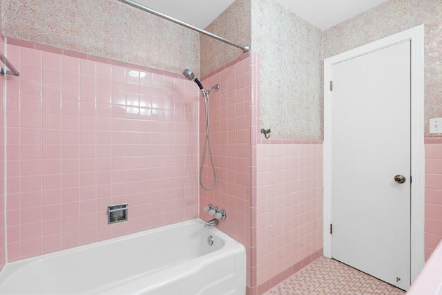 2333 Hermanson Dr, Waco, TX 76710 - full bathroom with tile walls, shower / bathtub combination, wallpapered walls, pet washing station, and tile patterned floors