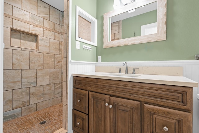 2333 Hermanson Dr, Waco, TX 76710 - full bathroom featuring wainscoting, vanity, and a tile shower