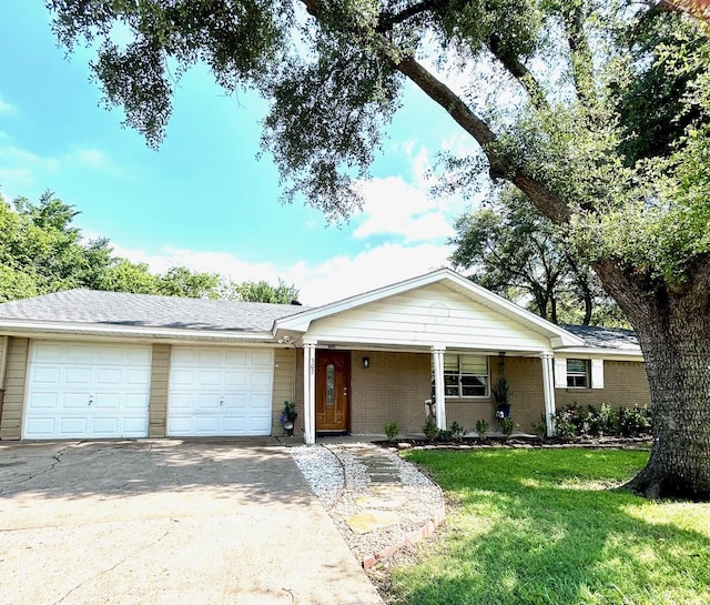 307 E 5th St, Kaufman, TX 75142 - ranch-style house featuring an attached garage, a front lawn, driveway, and brick siding