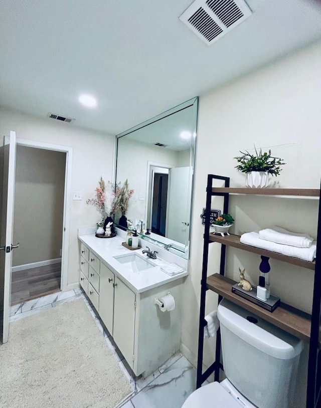 307 E 5th St, Kaufman, TX 75142 - bathroom with toilet and vanity