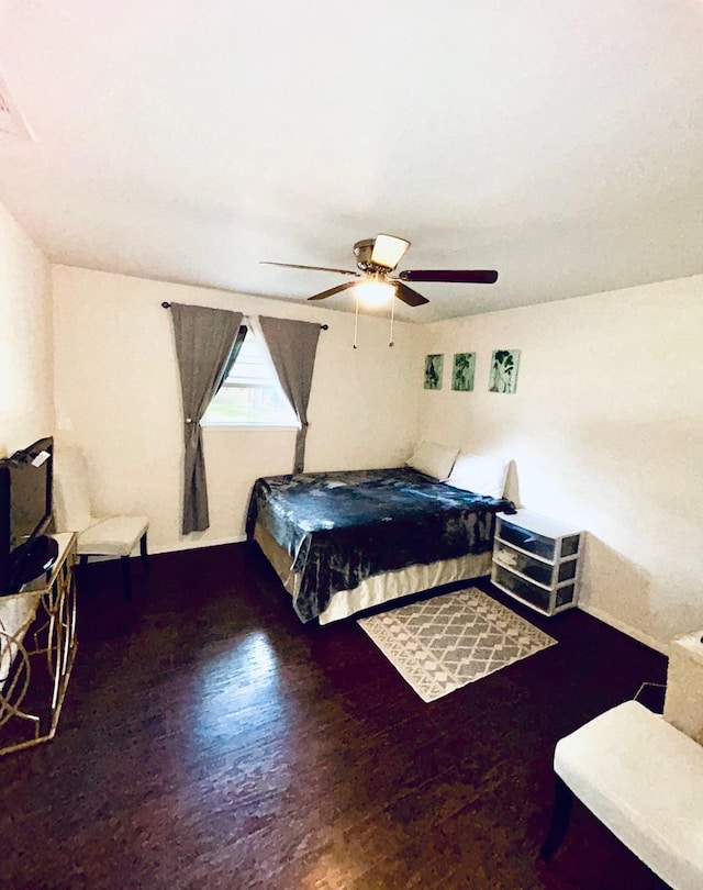 307 E 5th St, Kaufman, TX 75142 - bedroom with wood finished floors and a ceiling fan