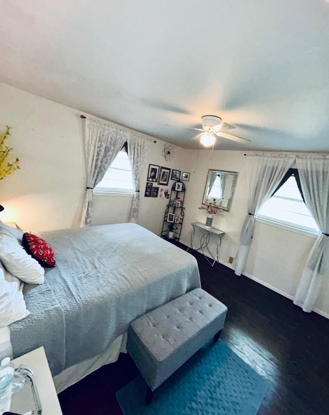 307 E 5th St, Kaufman, TX 75142 - bedroom with multiple windows, wood finished floors, and a ceiling fan