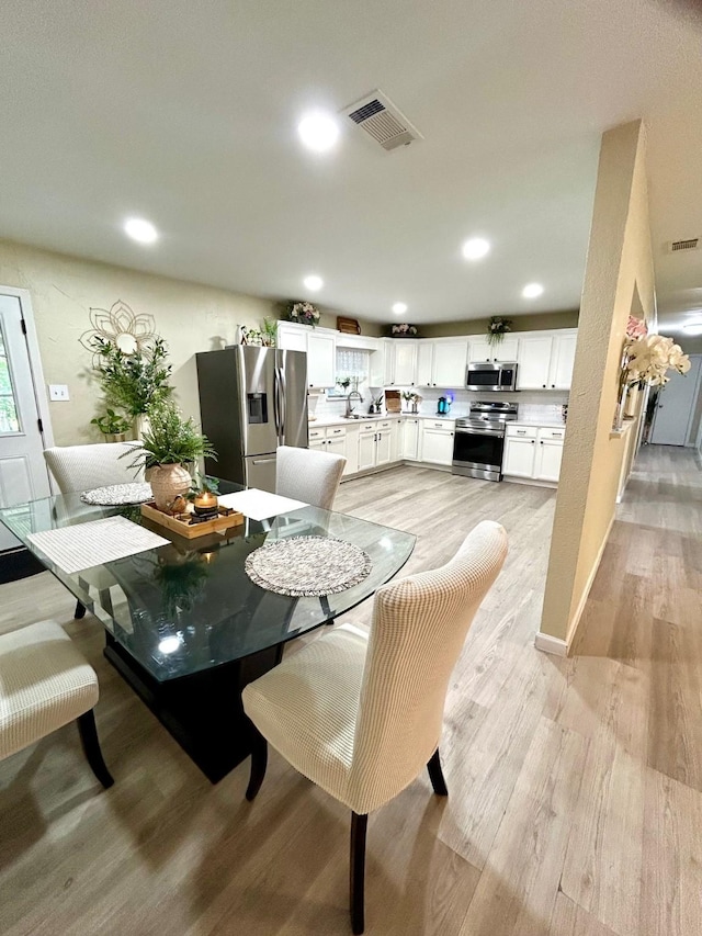 307 E 5th St, Kaufman, TX 75142 - dining space with light wood-style floors and recessed lighting