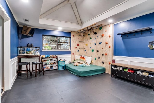 6211 White Rose Trl, Dallas, TX 75248 - game room featuring a decorative wall, a wainscoted wall, and concrete floors